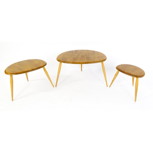 1869 - An Ercol 'Pebble' nest of three graduated occasional tables, constructed from ash and beech, the lar... 