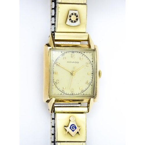 1046 - Masonic / Freemasonry Interest : A gentlemans 14ct gold cased Movado wristwatch with Arabic numerals... 