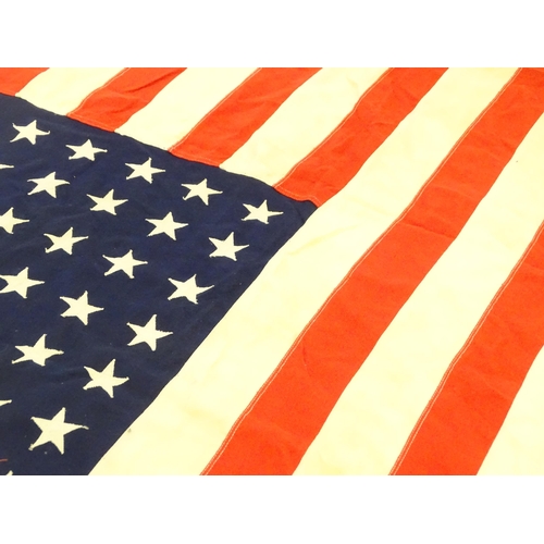 1500 - Militaria : a mid 20thC 'stars and stripes' flag of the United States of America, with 48 stars. App... 