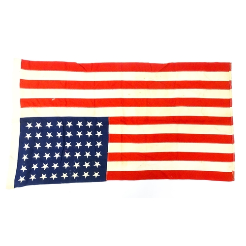 1501 - Militaria : a mid 20thC 'stars and stripes' flag of the United States of America, with 48 stars. Bea... 