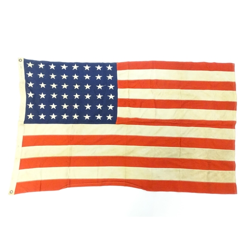 1502 - Militaria : a mid 20thC 'stars and stripes' flag of the United States of America, with 48 stars. Bea... 