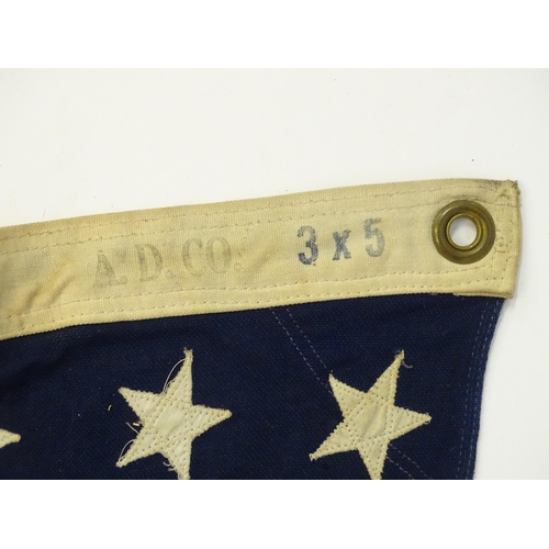 1502 - Militaria : a mid 20thC 'stars and stripes' flag of the United States of America, with 48 stars. Bea... 