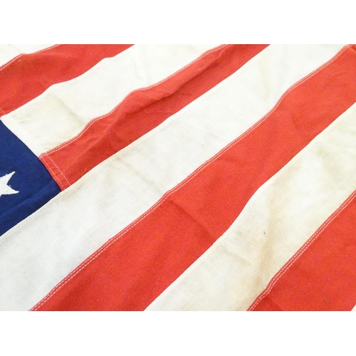 1502 - Militaria : a mid 20thC 'stars and stripes' flag of the United States of America, with 48 stars. Bea... 