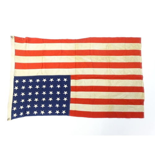 1502 - Militaria : a mid 20thC 'stars and stripes' flag of the United States of America, with 48 stars. Bea... 