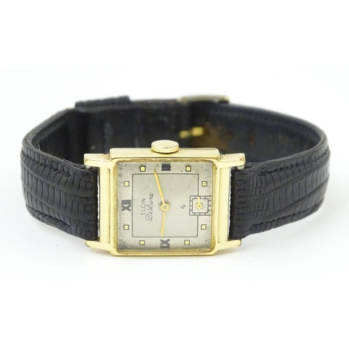 1037 - A vintage Elgin Deluxe 10k gold filled gentlemans wristwatch with squared dial and subsidiary second... 