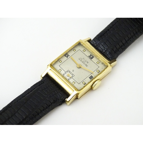 1037 - A vintage Elgin Deluxe 10k gold filled gentlemans wristwatch with squared dial and subsidiary second... 