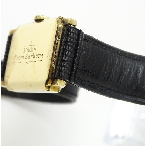 1037 - A vintage Elgin Deluxe 10k gold filled gentlemans wristwatch with squared dial and subsidiary second... 