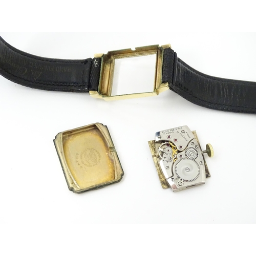 1037 - A vintage Elgin Deluxe 10k gold filled gentlemans wristwatch with squared dial and subsidiary second... 