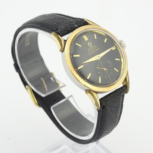 1040 - A gentlemans automatic stainless steel cased wristwatch the black dial signed 'Omega Automatic Seama... 