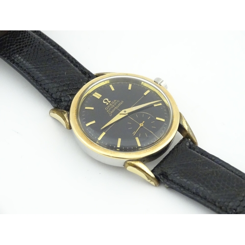 1040 - A gentlemans automatic stainless steel cased wristwatch the black dial signed 'Omega Automatic Seama... 