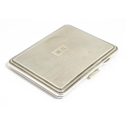 340 - An Art Deco silver compact of rectangular form with engine turned decoration hallmarked Birmingham 1... 