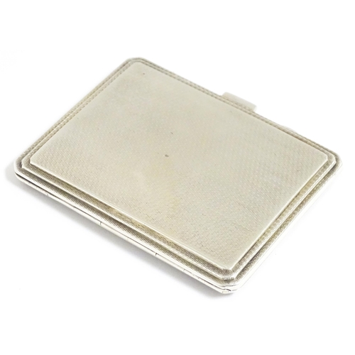 340 - An Art Deco silver compact of rectangular form with engine turned decoration hallmarked Birmingham 1... 