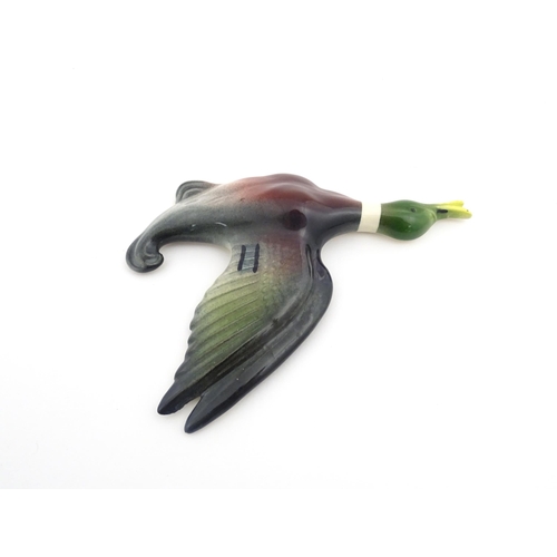 181A - A ceramic wall plaque modelled as a mallard duck in flight painted by Peter Scott. Marked under. App... 