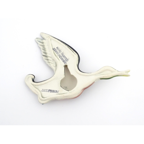 181A - A ceramic wall plaque modelled as a mallard duck in flight painted by Peter Scott. Marked under. App... 