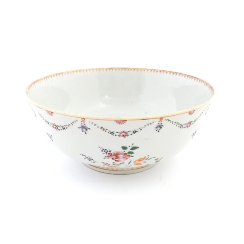 2 - A Chinese famille rose bowl decorated with floral garlands and flower motifs.  Approx. 4 1/4