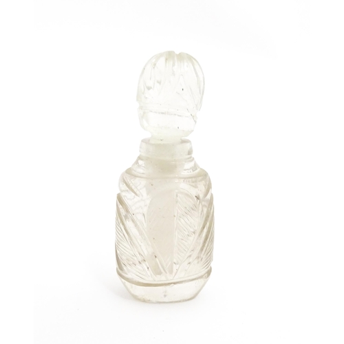 237 - A late 19th / early 20thC carved rock crystal perfume / scent bottle. Approx. 2 1/4