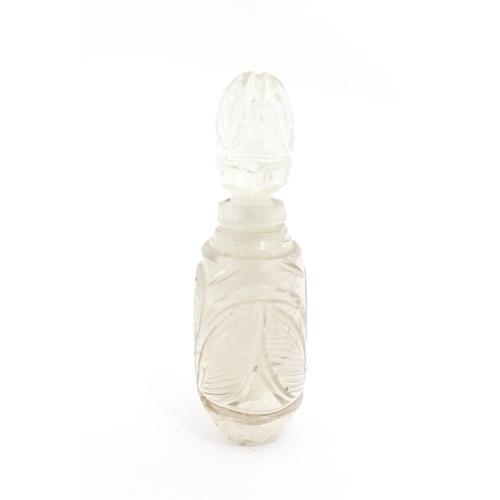 237 - A late 19th / early 20thC carved rock crystal perfume / scent bottle. Approx. 2 1/4