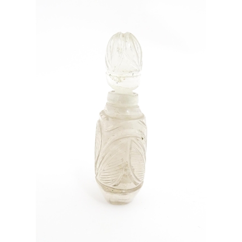 237 - A late 19th / early 20thC carved rock crystal perfume / scent bottle. Approx. 2 1/4