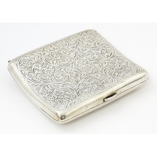 391 - A silver cigarette case of shaped form with engraved acanthus scroll decoration hallmarked Birmingha... 