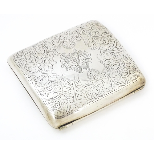 391 - A silver cigarette case of shaped form with engraved acanthus scroll decoration hallmarked Birmingha... 