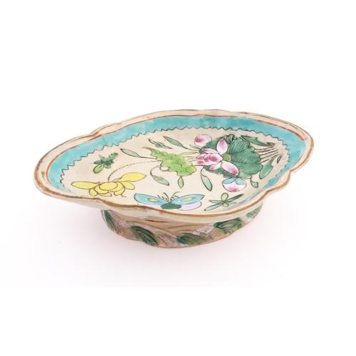 11 - A Chinese footed dish of shaped form decorated with flowers, foliage and butterflies. Approx. 2