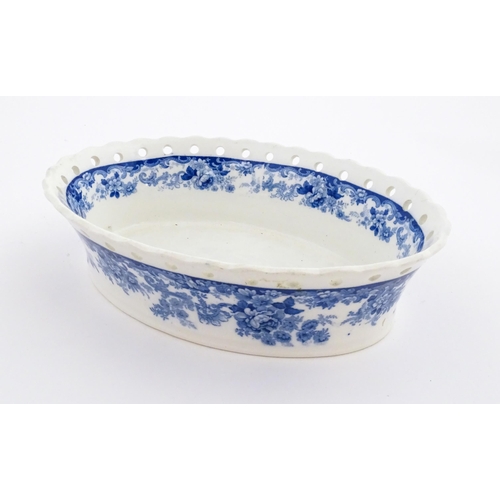 115 - A Mintons blue and white chestnut bowl with banded floral decoration and pierced rim. Marked under. ... 