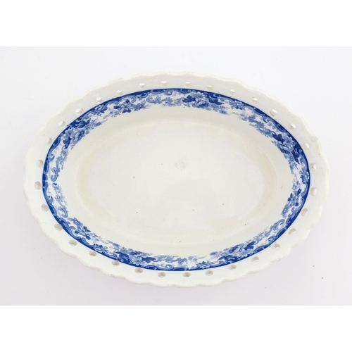 115 - A Mintons blue and white chestnut bowl with banded floral decoration and pierced rim. Marked under. ... 