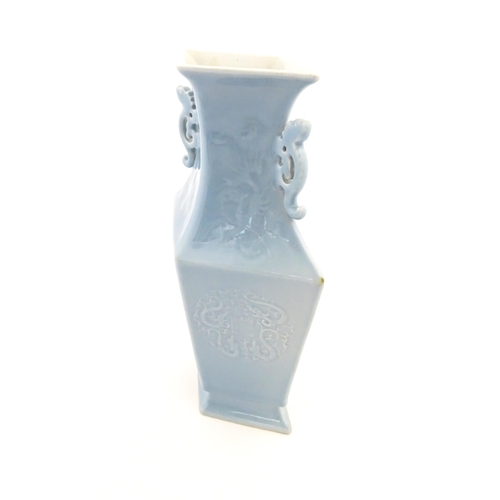 16 - A Chinese vase of angular baluster form with a pale blue ground and twin handles, decorated with pho... 