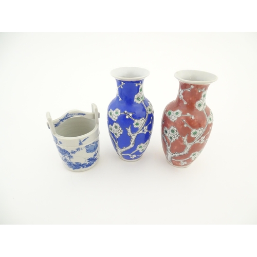 17 - A Chinese blue a white model of a pail with floral decoration. Together with two vases decorated wit... 