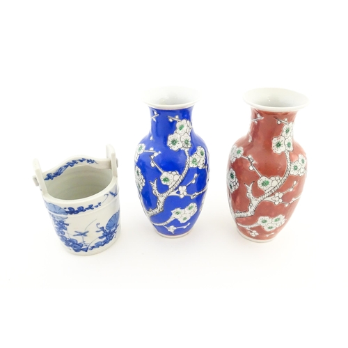 17 - A Chinese blue a white model of a pail with floral decoration. Together with two vases decorated wit... 
