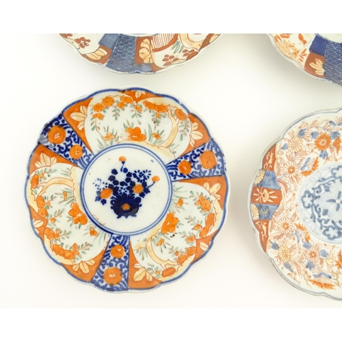 25 - Six assorted Japanese plates with scalloped edges decorated in the Imari palette with flowers and fo... 