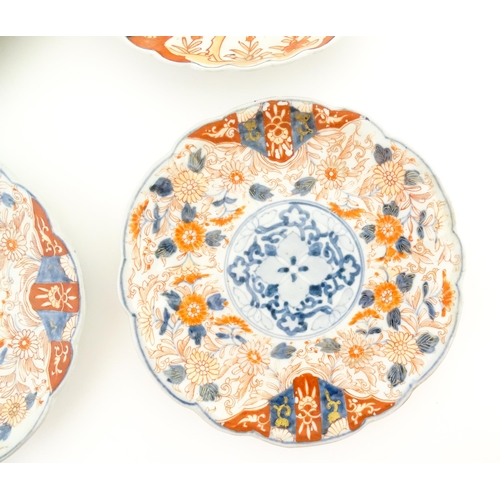 25 - Six assorted Japanese plates with scalloped edges decorated in the Imari palette with flowers and fo... 