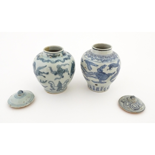 27 - Two Chinese blue and white lidded jars / vases decorated with stylised phoenix birds in flight. Appr... 