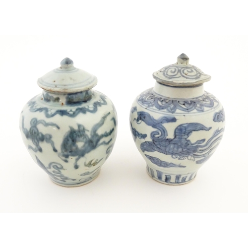 27 - Two Chinese blue and white lidded jars / vases decorated with stylised phoenix birds in flight. Appr... 