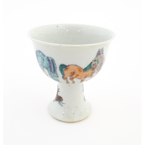 29 - A Chinese pedestal wine cup / bowl decorated with horses. Character marks under. Approx. 5