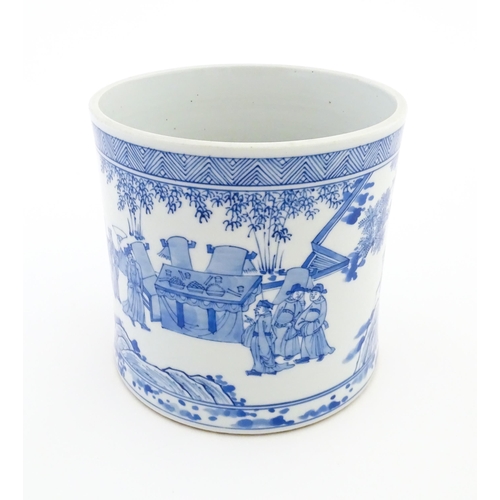32 - A Chinese blue and white vase / planter decorated with figures in a garden setting with a feast, and... 