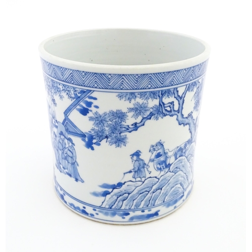 32 - A Chinese blue and white vase / planter decorated with figures in a garden setting with a feast, and... 