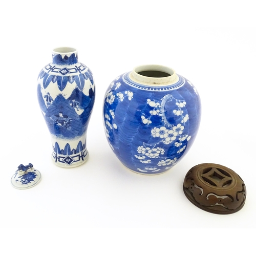 50 - A Chinese blue and white lidded vase decorated with a landscape scene with warriors, the lid surmoun... 