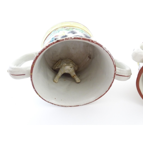 59A - Two Staffordshire pottery loving cups / frog mugs, one with relief decoration depicting a hunting do... 