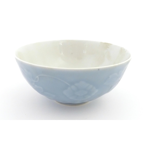 6 - A Chinese bowl with a blue ground decorated with flowers and petals. Character marks under. Approx. ... 