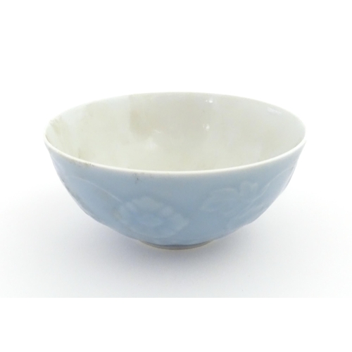 6 - A Chinese bowl with a blue ground decorated with flowers and petals. Character marks under. Approx. ... 