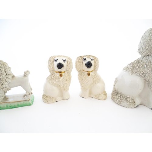 60 - A quantity of assorted Victorian and later Staffordshire style poodle dogs. Largest approx. 4 1/2