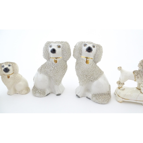 60 - A quantity of assorted Victorian and later Staffordshire style poodle dogs. Largest approx. 4 1/2