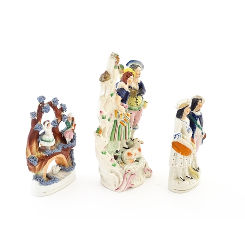 61 - Three Victorian Staffordshire pottery flatback figural groups, to include a couple with a lamb, two ... 