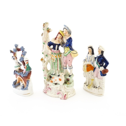 61 - Three Victorian Staffordshire pottery flatback figural groups, to include a couple with a lamb, two ... 