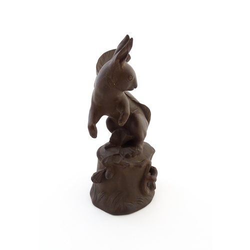 71 - A Bottger Steinzeug Meissen stoneware model of a squirrel perched on a tree stump. Marked under. App... 