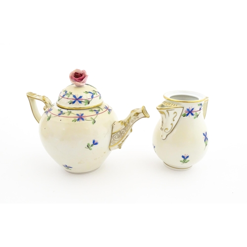 83 - A Herend porcelain teapot decorated in the Cornflower pattern with floral decoration and gilt highli... 