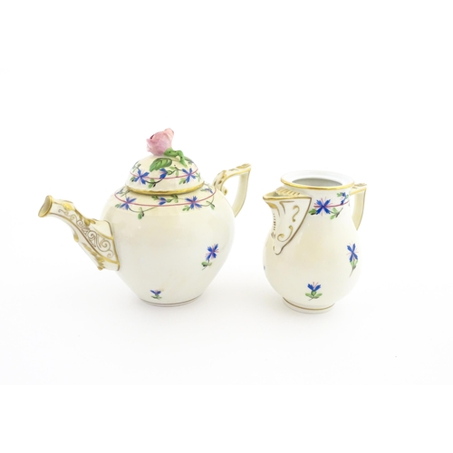 83 - A Herend porcelain teapot decorated in the Cornflower pattern with floral decoration and gilt highli... 