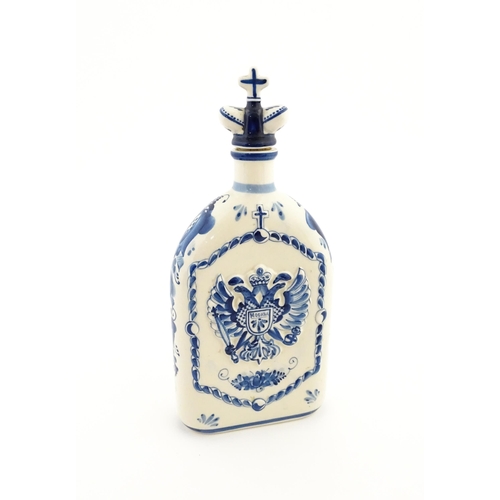 86 - A Russian Shekma Gzhel blue and white ceramic bottle and stopper / decanter decorated with castle to... 