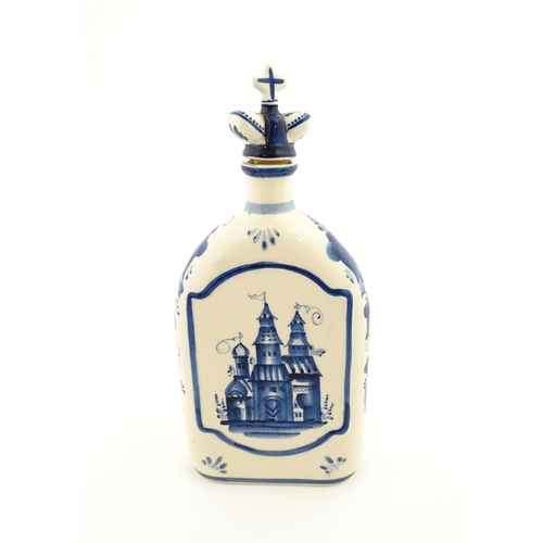 86 - A Russian Shekma Gzhel blue and white ceramic bottle and stopper / decanter decorated with castle to... 